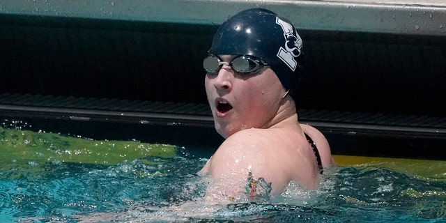 Iszac Henig of Yale University reacts after setting a pool record in the 50-yard freestyle qualifying event at the Harvard Women's Ivy League Swimming and Diving Championships, Thursday, Feb. 17, 2022, in Cambridge, Massachusetts.