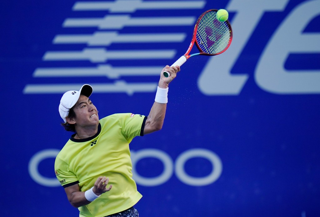 Yoshihito Nishioka of Japan returns the ball during a match against Daniil Medvedev.