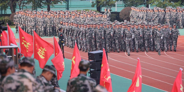 New students take part in military training at Southeastern University on October 22, 2021 in Nanjing, Jiangsu Province, China.