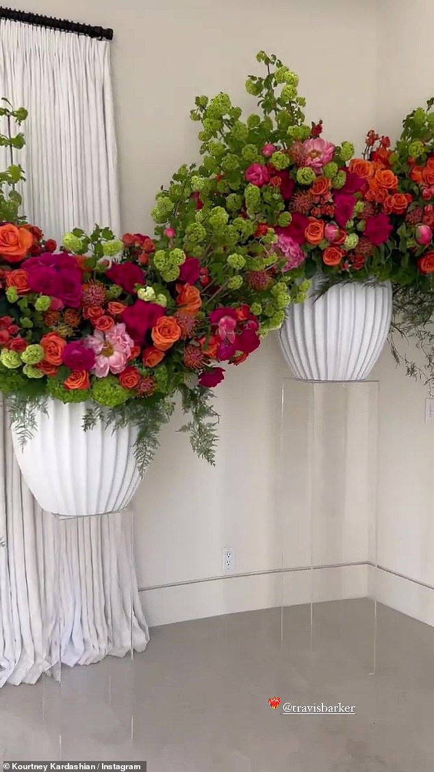 Fresh: Colorful floral arrangements brighten a neutral-colored foyer.  She even put a bouquet of flowers outside in her yard