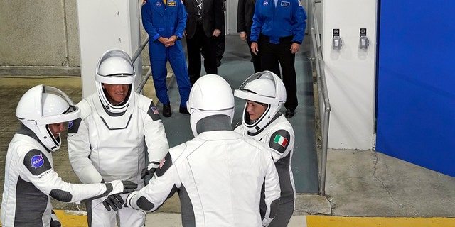 SpaceX Crew-4 astronauts, left, mission specialist Jessica Watkins, pilot Bob Hines, Commander Kjell Lindgren and mission specialist ESA astronaut Samantha Cristoforetti, of Italy, gather together after leaving the operations building and propulsion for a flight to the launch complex. 39-A Wednesday, April 27, 2022, at the Kennedy Space Center in Cape Canaveral, Florida.