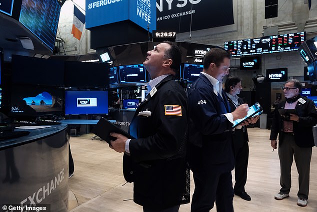 On Thursday, the S&P 500 index was crawling toward confirming a bear market, Wall Street's term for a 20 percent drop from recent highs.  Pictured: Traders at the New York Stock Exchange