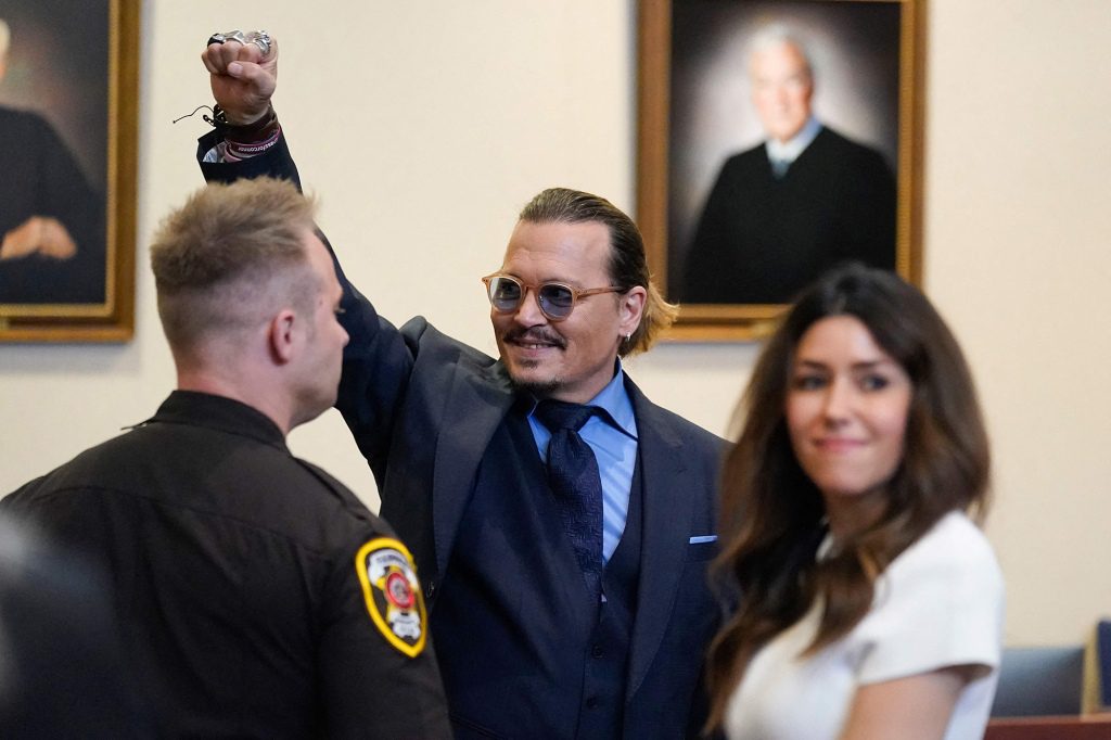 Depp pumps his fist in the courtroom on May 27.