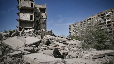 A boy sits on the ruins of a building injured in a raid on Kramatorsk, a city in the Donetsk region.