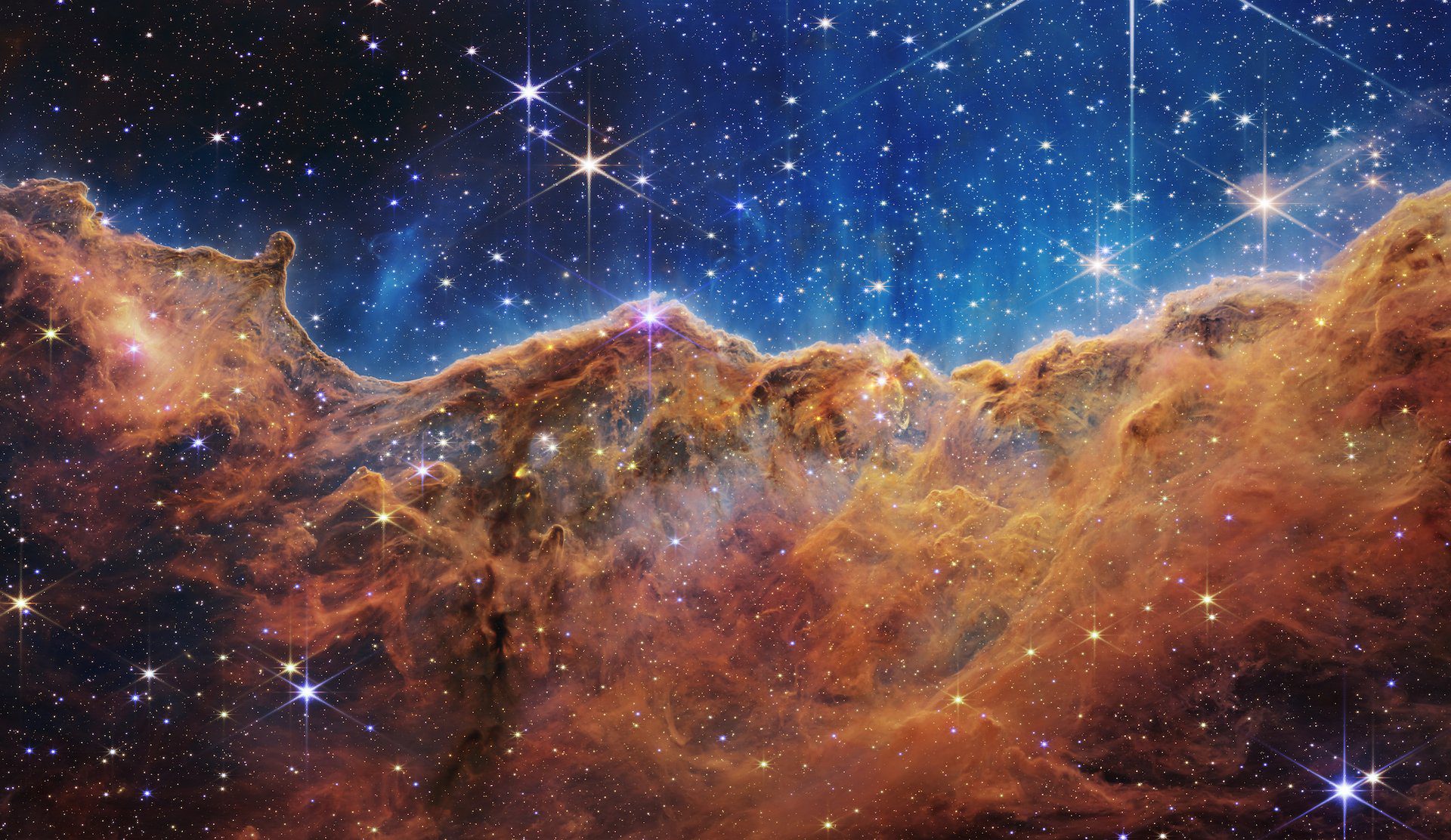 Clouds of dust and gas of the Carina Nebula, where stars are forming, imaged by the James Webb Telescope.