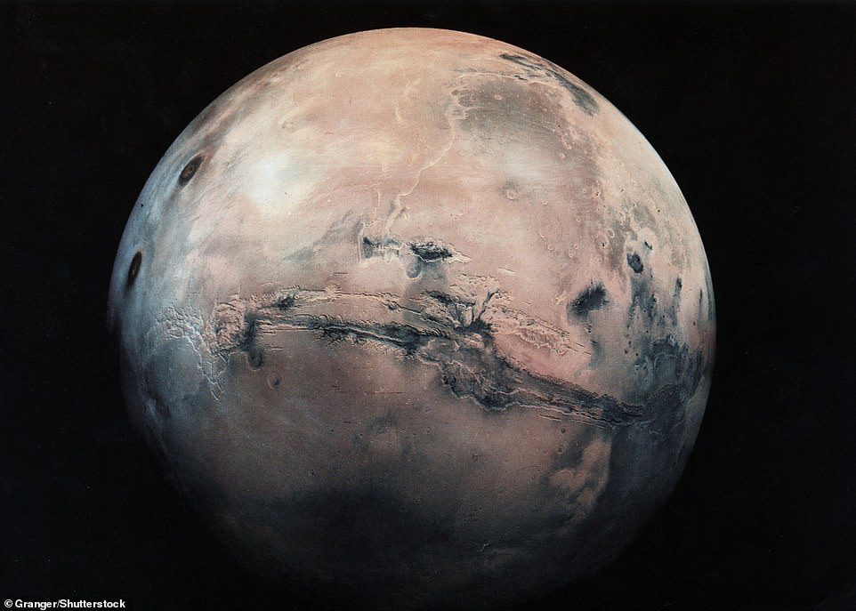 The Red Planet's massive Valles Marineris—which spans roughly a quarter of the planet's circumference—is visible above (center) in this image from the Granger Group.