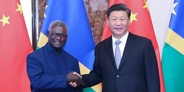 Chinese President Xi Jinping meets with Solomon Islands Prime Minister Manasseh Sogavary in Beijing, October 9, 2019.