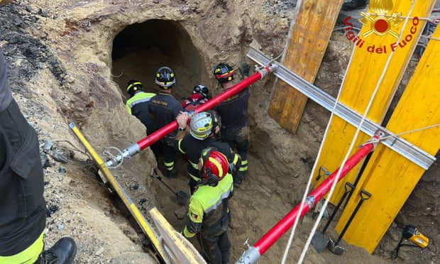 First responders inspect a tunnel discovered after part of a road collapsed in central Rome