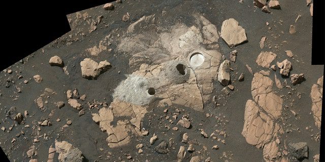 This mosaic consists of multiple images from NASA's Mars probe, and shows a rocky outcrop called "Wild Cat Ridge" The rover extracted two rocky cores and scraped a circular patch to check the rock's composition. 