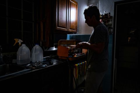 A person cooks in the dark on Monday after losing power in San Juan, Puerto Rico.