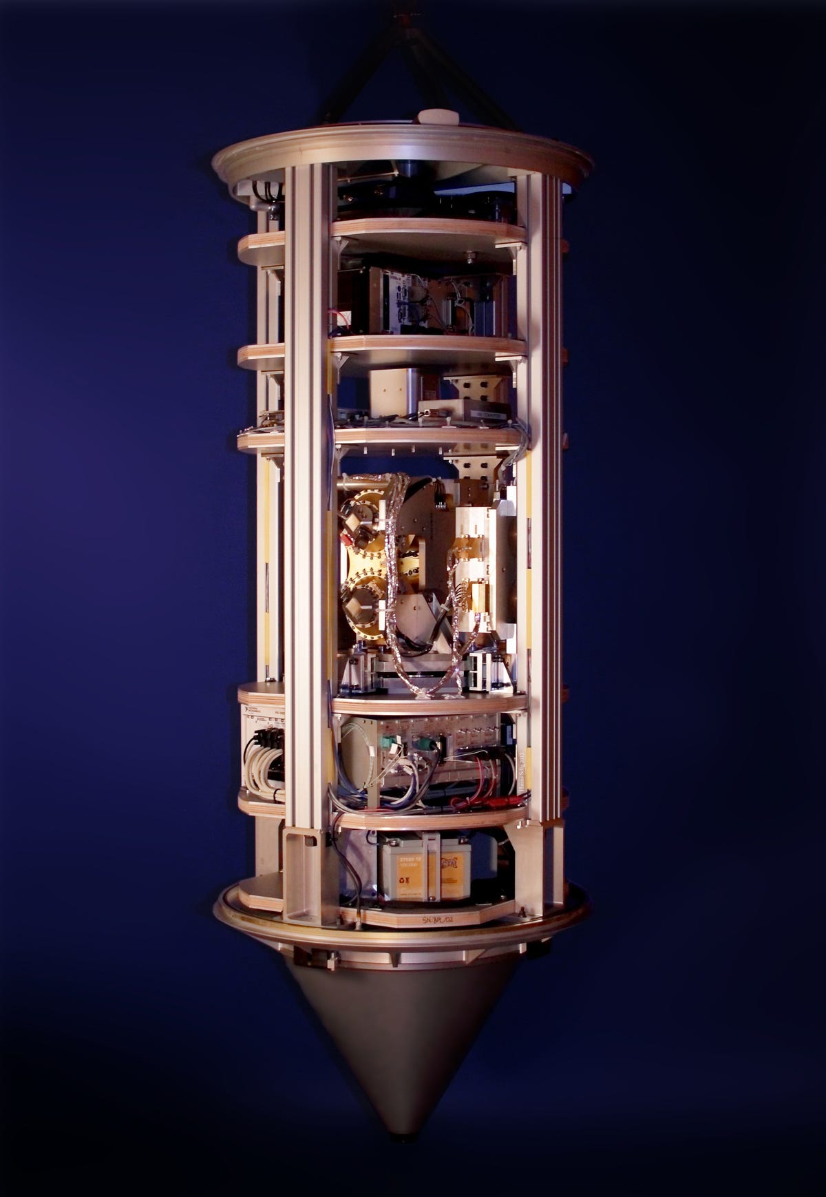 Bronze cylindrical body holding scientific instruments with a pointed bottom